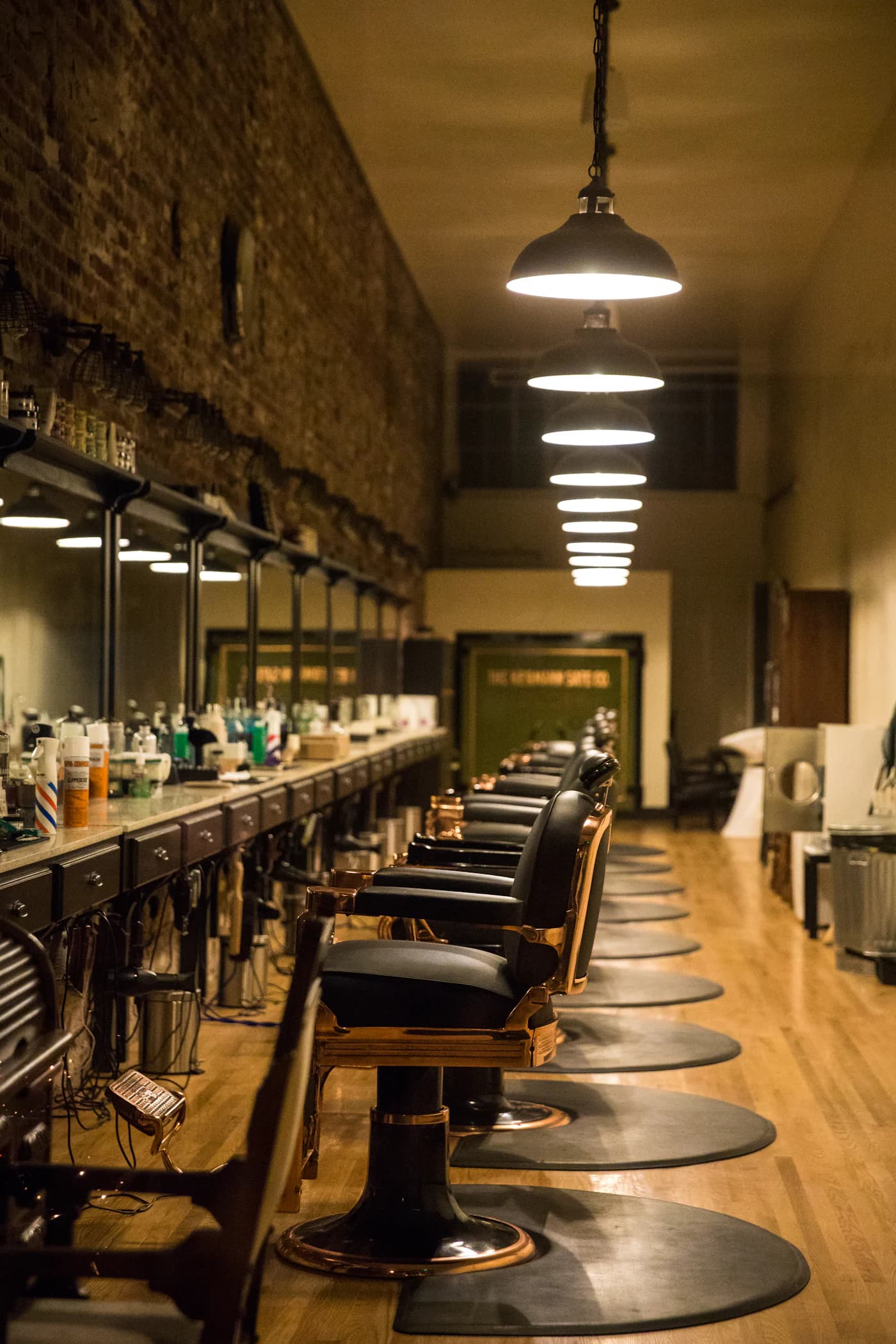 The salon floor at Hair Xpressions, styling stations beneath pendant lighting